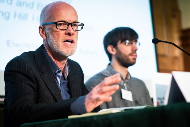 Corporate event photography of a panel discussion during a large conference.