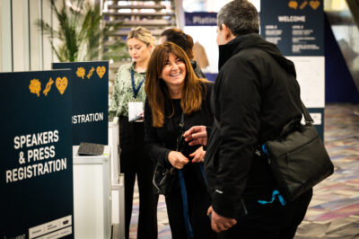 People Arriving At A Conference